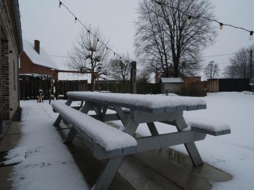 a picnic table covered in snow in a yard at Bocholt Family Home, Bocholt in Bocholt