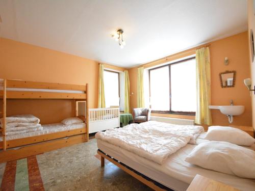 a bedroom with two beds and a large window at Spacious retreat, Daverdisse in Daverdisse