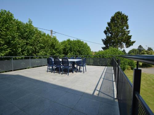 a patio with chairs and a table on a fence at Spacious retreat, Daverdisse in Daverdisse