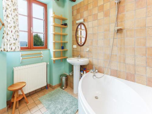 a bathroom with a tub and a sink and a toilet at Holiday Home in Diges with Garden & Cycling in Sauilly