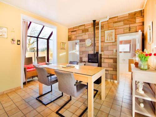 a dining room with a wooden table and chairs at Holiday Home in Hollebeke with Private Garden in Zandvoorde