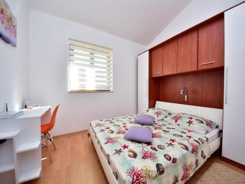a bedroom with a bed and a desk in it at Holiday Home in Krusevo with Garden & BBQ in Kruševo