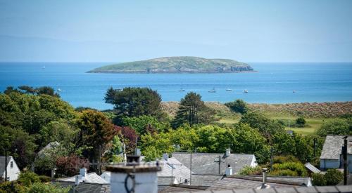 an island in the water with houses and boats at Kookaburra in Abersoch