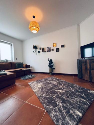 a living room with a couch and a tv at Da Toni FeWo Chiara in Rüdesheim am Rhein