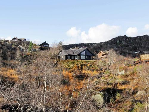 una casa situada en la cima de una colina en 10 person holiday home in ÅSERAL, en Åseral