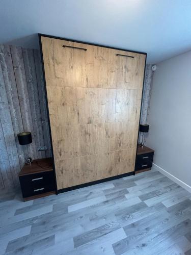 a large wooden wall in a room with two tables at Somewhere Nice & Cozy in Little Clacton