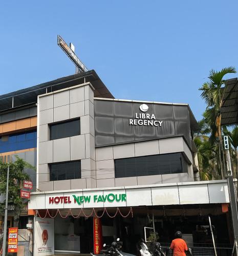 a building with a sign on the front of it at LlBRA REGENCY in Guruvāyūr