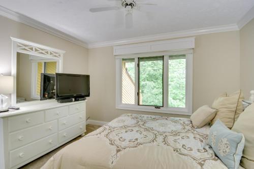 a white bedroom with a bed and a tv at Harbor Springs Condo about 6 Mi to Lake Michigan! in Harbor Springs