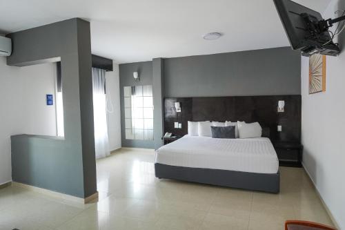 a bedroom with a large white bed in a room at Days Inn by Wyndham Minatitlan in Minatitlán