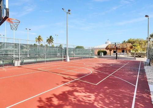 an empty tennis court with a basketball hoop at Oceanview Retreat with 60ft Seawall in Cudjoe Key