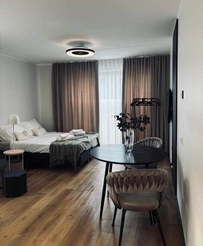 a room with a table and a bed and a bedroom at Lootuse 2a in Tartu