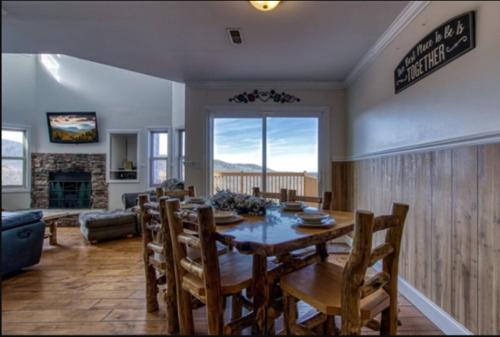 a living room with a dining room table and chairs at Top of World in Gatlinburg