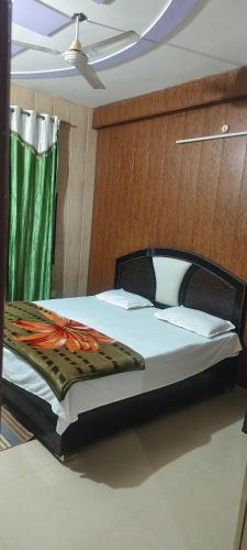 a bedroom with a bed with an orange flower on it at Shreeji homestay in Chhatikara