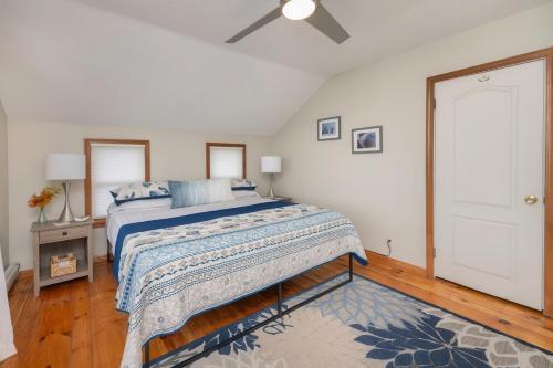 a bedroom with a bed and a ceiling fan at Waterfront Sodus Gem, Dock Game Loft Bay View in Sodus Point