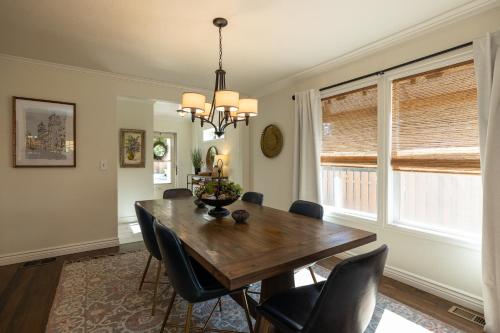 a dining room with a wooden table and chairs at East Bench Bungalow A Relaxing Ogden Escape Near Mountains and Downtown in Ogden