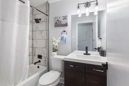 a bathroom with a sink and a toilet and a shower at Private Fenced Yard Near Truist Park and ATL in Marietta