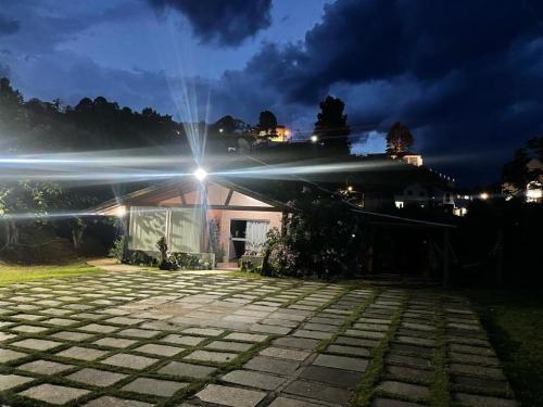 a house with a light on the roof at night at Spaço Terra hospedagem in Domingos Martins