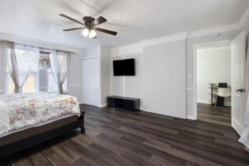 a bedroom with a bed and a ceiling fan at Private Fenced Yard Near Truist Park and ATL in Marietta