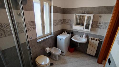 a bathroom with a toilet and a sink and a shower at ITALY-HOUSE Piviere 5 UP, Termoli, Molise in Termoli