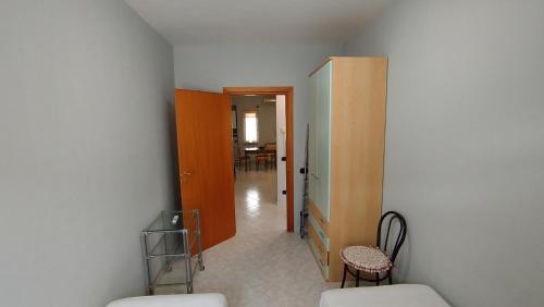 a room with a hallway with a chair and a table at ITALY-HOUSE Piviere 5 UP, Termoli, Molise in Termoli