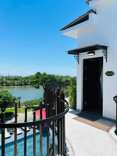 a view from the balcony of a house with a river at Happy Life Memories Hoi An Hotel & Spa in Hoi An