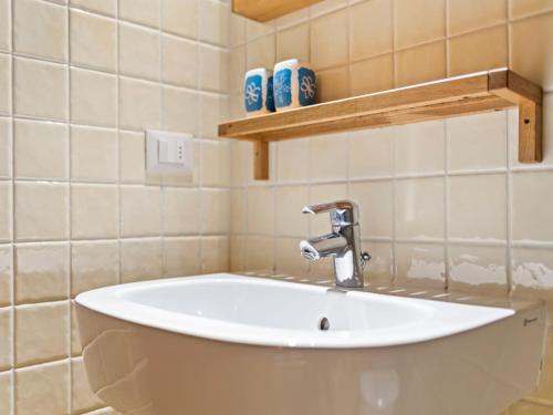 a bathroom with a white sink in a room at Holiday Home in Ca' De' Grimaldi with Garden in Castellarano