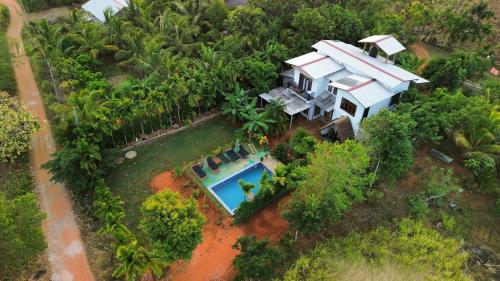 an aerial view of a house with a swimming pool at Dew Ashi Homestay in Sigiriya