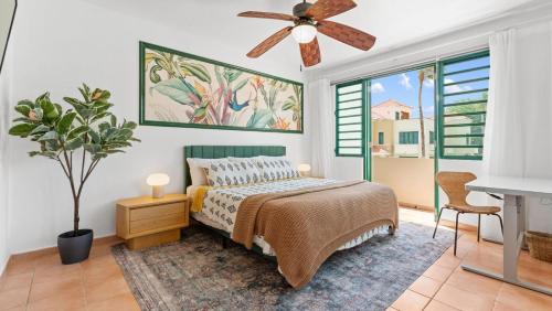 a bedroom with a bed and a ceiling fan at Beachfront Surf House-Family Fun, Pool and Solar in Rincon