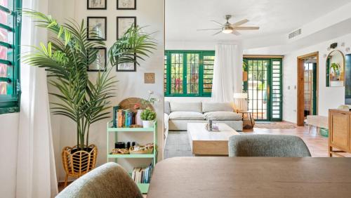 a living room with a couch and a table at Beachfront Surf House-Family Fun, Pool and Solar in Rincon