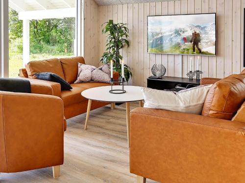 a living room with two couches and a table at 5 star holiday home in Stege in Stege