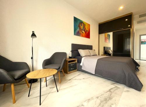 a bedroom with a bed and two chairs and a table at DREAM VIEW Saguramo in Saguramo