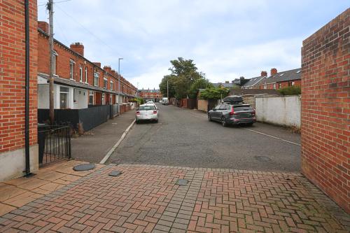 an empty street with cars parked on the street at Ardenlee Drive in Belfast