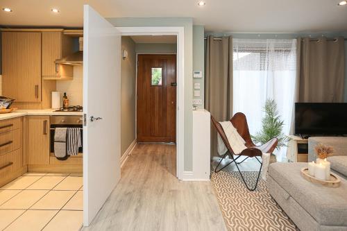 a kitchen and living room with a couch and a chair at Ardenlee Drive in Belfast
