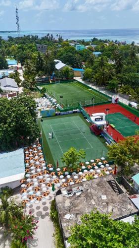 an aerial view of two tennis courts with umbrellas at ROYAL Village Dhangethi Maldives in Male City