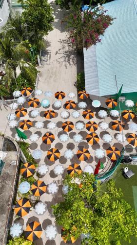 an aerial view of a patio with umbrellas at ROYAL Village Dhangethi Maldives in Male City