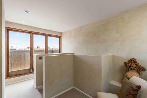 a living room with a couch and a large window at Sanctuary House with Parking By My Getaways in Shoreham-by-Sea