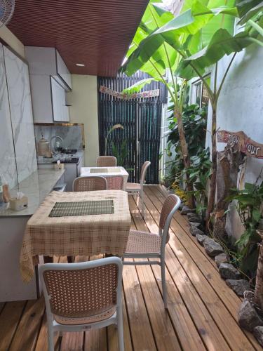 a patio with a table and chairs on a wooden deck at ROYAL Village Dhangethi Maldives in Male City