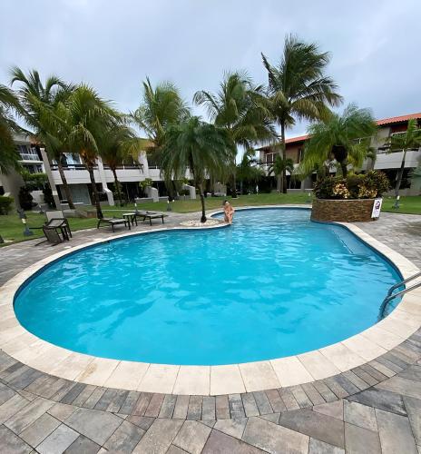 a pool at the resort with a person sitting in it at Aruba , Eagle Beach Townhouse in Palm-Eagle Beach