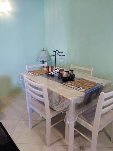 a dining room table with two chairs and a table with at Tropical Apartment with private patio, Walk to Beaches, Shops and Cafes in Saint Peter