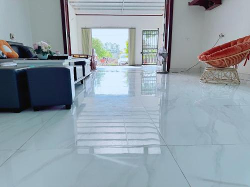 a living room with a couch and a chair at Villa Ngân Hà in Kon Rung (1)