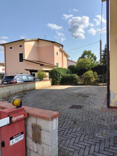 a building with a car parked in a driveway at Cozy Corner near Lucca in Chiesina Uzzanese