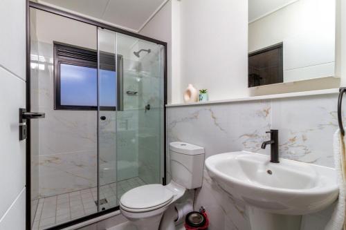 a bathroom with a toilet and a sink and a shower at AlimamaSpaces Panos Whisken in Midrand