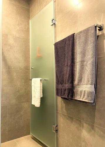 a shower with a glass door in a bathroom at DREAM VIEW Saguramo in Saguramo
