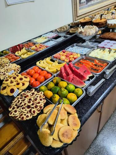 a buffet with many different types of fruits and vegetables at Hotel Graunas in São Carlos