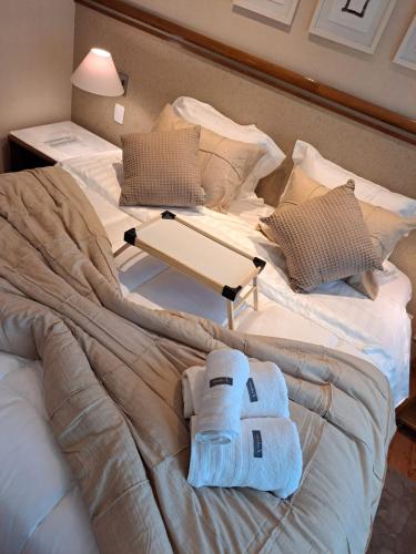 a bed with a towel on top of it at Conforto Flat Hotel Vila Olimpia in São Paulo