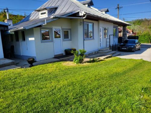 a house with a car parked in front of it at Casa SOFI Nr 1, Breaza PH in Breaza