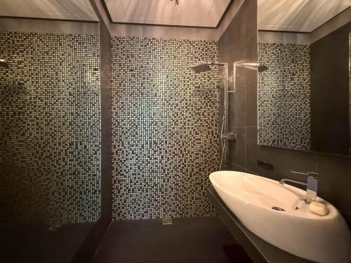 a bathroom with a sink and a shower at City Center Apartment in Belgrade