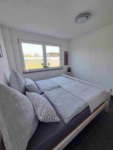 a bedroom with a large bed and a window at FeWo Müller in Simmersfeld