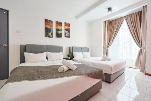 a bedroom with two beds and a large window at Cloverhill Emerald Avenue Apartment Highland Elegance Stay Clover Home 5-03 in Brinchang