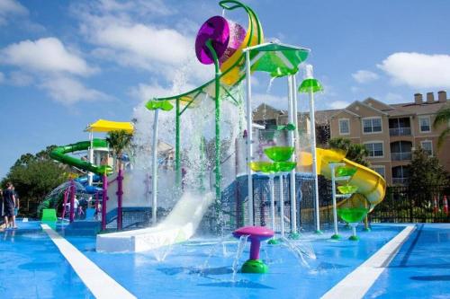 a pool with a water park with a water slide at 3 Bedroom Condo with Water Park & Fantastic Pool only Minutes To Walt Disney World's Front Gate!!! in Orlando
